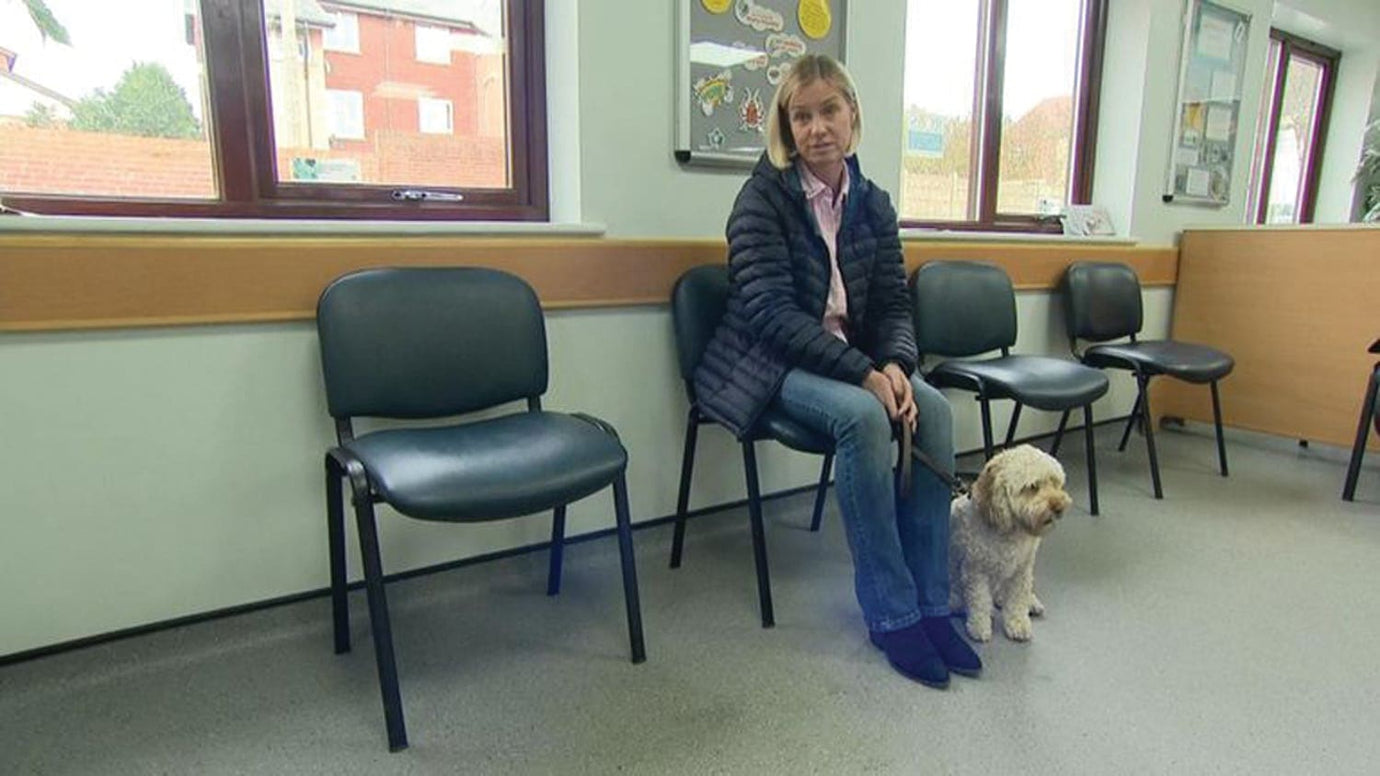 pet owner with dog waiting in the waiting room