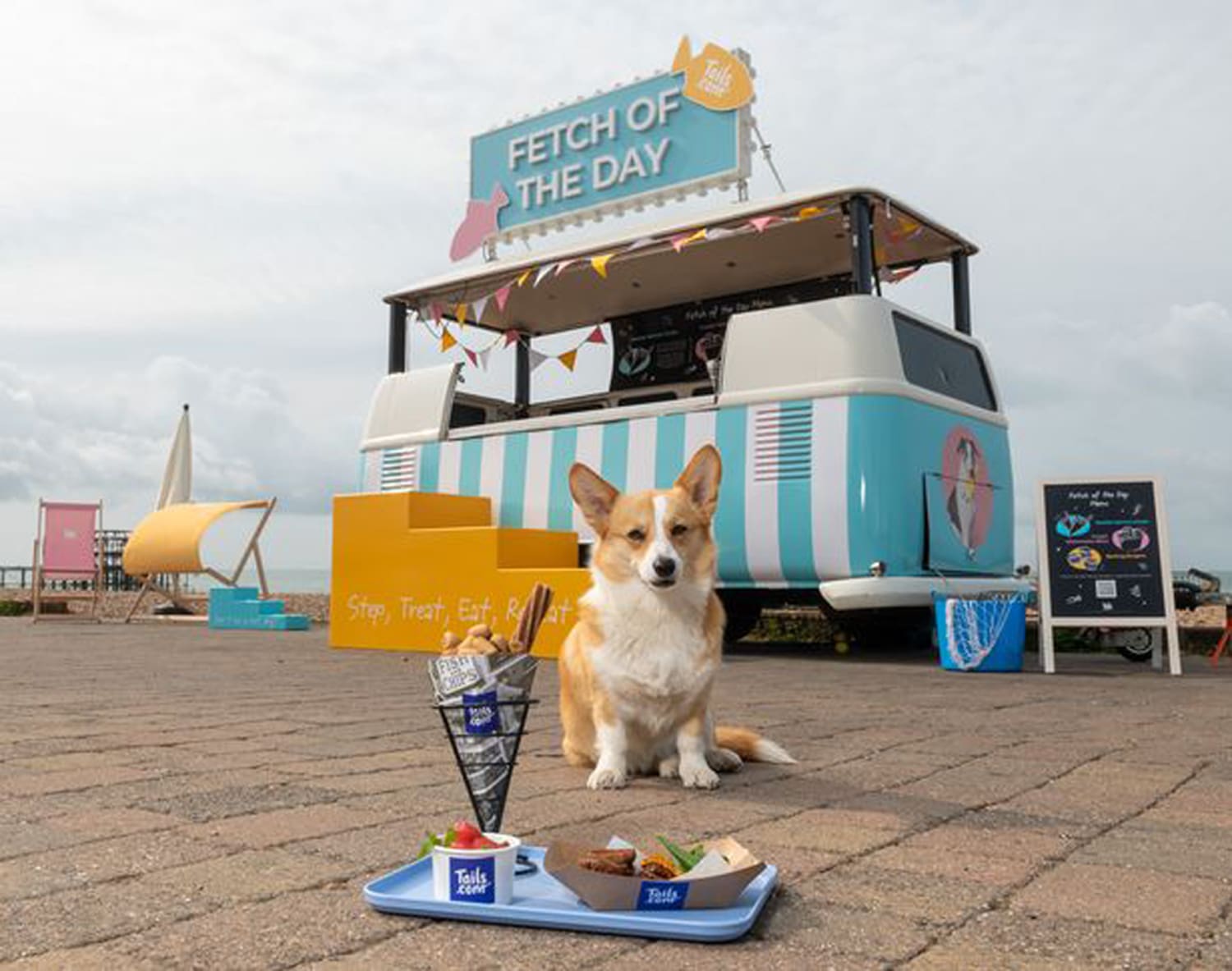 happy dog in front of a food stall