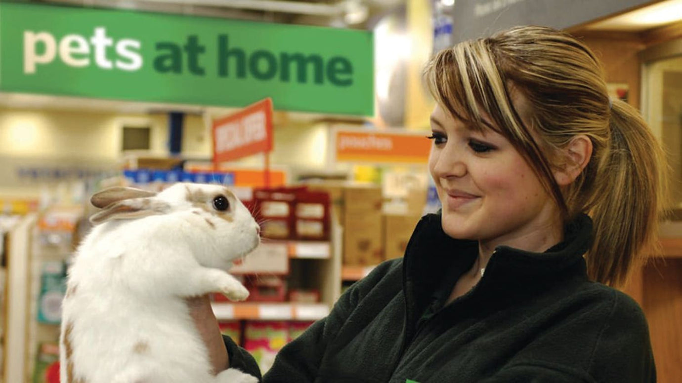 Pet owner in front of Pets At Home shop 