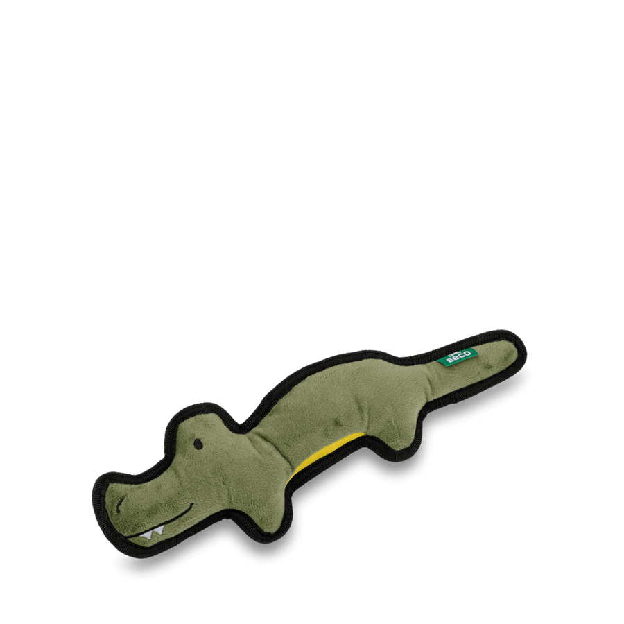 A plush crocodile toy made of recycled materials, with a green body and a yellow belly.
